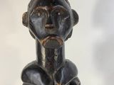a close up of a statue of a person with a hat on