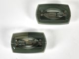 two pieces of green plastic on a white surface