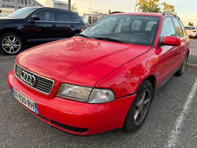 a red car parked in a parking lot next to other cars