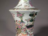 a white vase with a floral design on it