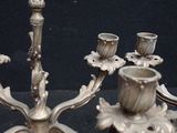 a silver candelab that is on display on a table