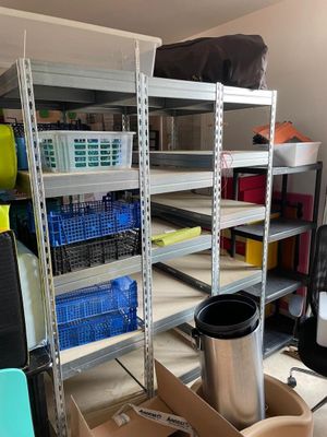 a room that has a lot of shelves and bins in it