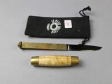 a knife and a small pouch on a table