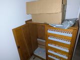 a cardboard box sitting on top of a dresser in the corner of a room