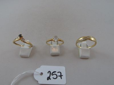 three rings and a price tag on a white table