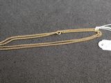 a gold chain with a heart charm on it