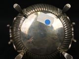 a silver ring with a blue dot on it