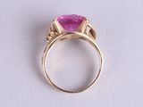 an image of a pink stone ring on a white surface