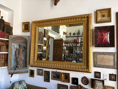 a picture of a living room with a lot of pictures on the wall