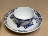 a cup and saucer sitting on a table