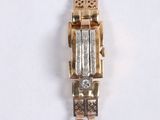 an image of a gold and silver watch on a white surface