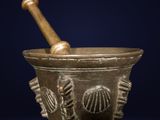 an old mortar with a wooden pestula in it on a blue background