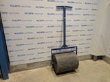 a roller that is sitting on the floor in front of a wall