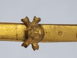 a close up of a gold colored object on a white background