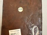 a brown book with a tag on it sitting on a table