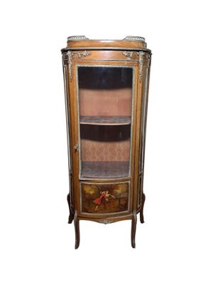 an image of a corner cabinet with a glass door and drawers