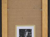 a black and white photo of a man in a hat and a woman in a dress in a frame
