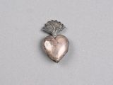a close up of a heart shaped object on a white surface