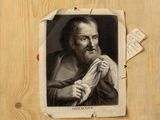 an old picture of a man with a beard holding a piece of paper