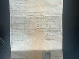a receipt on a car seat with a cell phone next to it