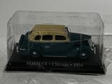 a toy car in a glass case on a white surface