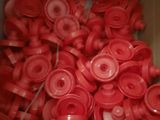 a box full of red plastic buttons in it