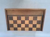 an old wooden chess board with a checkered pattern on it