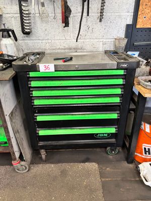 a picture of a workbench in a garage with tools hanging on the wall