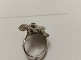 a close up of a silver ring on top of a piece of paper