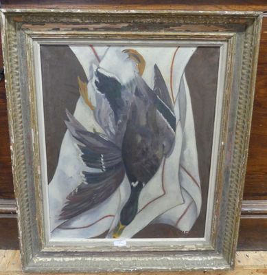 painting of a bird in a frame on a wooden floor