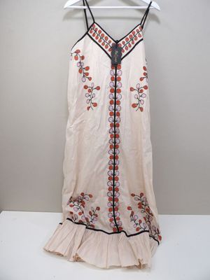 an image of a dress hanging on a hanger on a wall