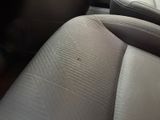 a close up of a seat in a car with the arm rest down