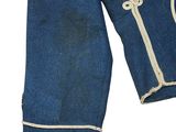 an old pair of blue jeans with white stitching on them