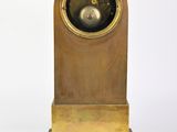 a clock that is sitting on top of a wooden stand