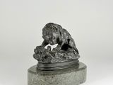 statue of a lion on a rock on a white background