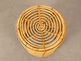 a small wicker basket with a spiral design on it