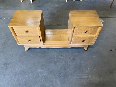 a wooden table with two drawers on it in a room
