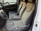 the interior of a van with the door open and the passenger seat down