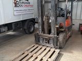 a forklift truck parked in a warehouse next to a truck