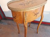 a small wooden table with a drawer on top of it