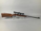 a rifle on a stand with a scope on it