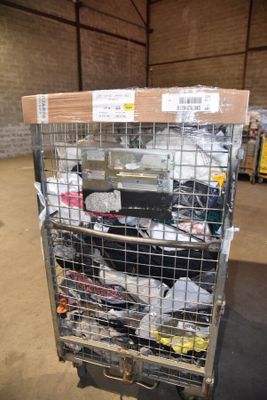 a metal cart with many items in it in a warehouse