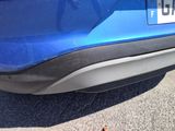 a close up of a blue car with a number plate on it