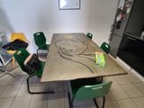 a table and chairs in a room with a refrigerator