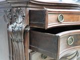 a wooden dresser with two drawers and a mirror on top