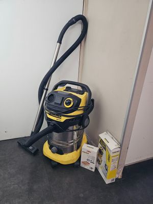 a yellow vacuum and a box of boxes on the floor