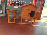 a chicken coop with a green roof in a store
