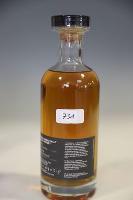 an empty bottle of alcohol sitting on top of a white table
