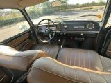 a view of the inside of a car from the driver ' s seat