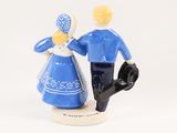 a figurine of a man and a woman holding hands